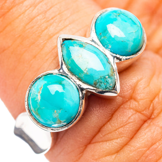 Turquoise cabochon sterling silver ring with three round stones on a band
