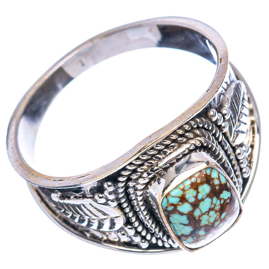 Sterling silver turquoise cabochon ring with detailed scrollwork, angled view