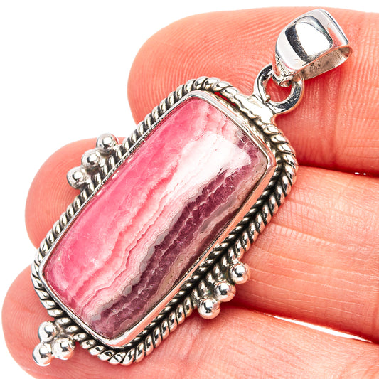Oval rhodochrosite pendant with pink striped stone and beaded .925 sterling silver border