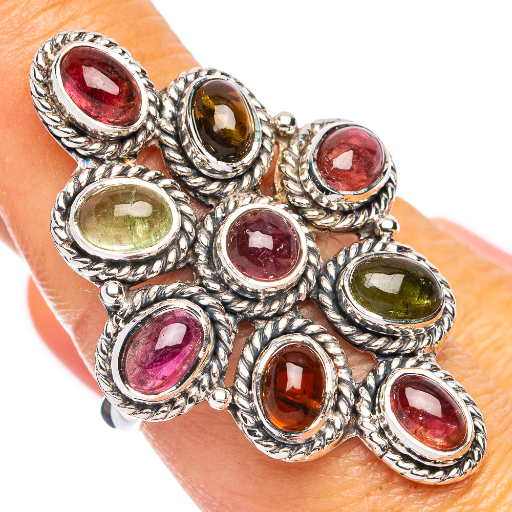 Oval multi-gem sterling silver ring with red, green, and amber stones, textured bezel