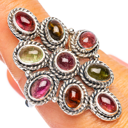 Oval multi-gem sterling silver ring with red, green, and amber stones, textured bezel