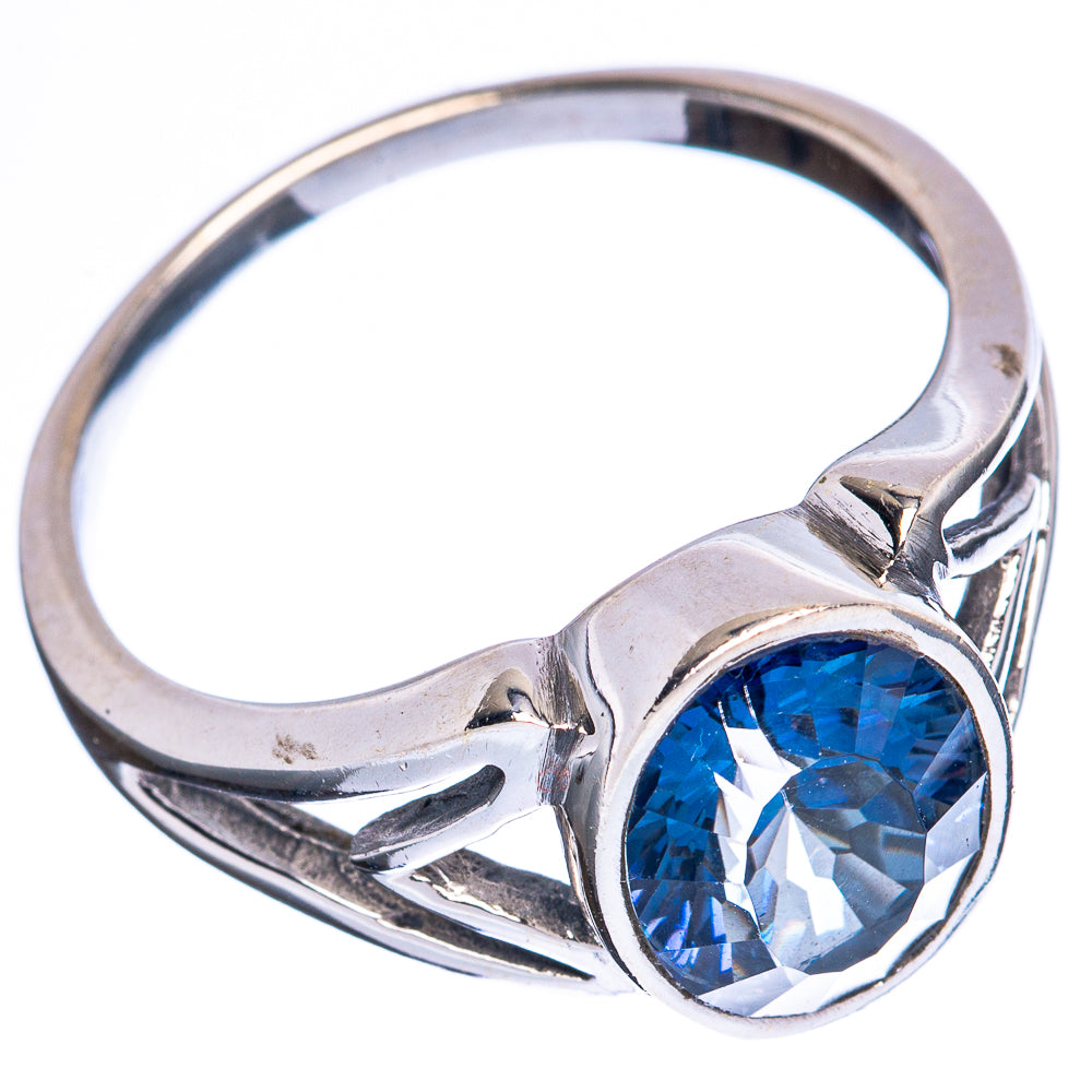 Sterling silver ring with round blue gemstone and leaf-like band detail