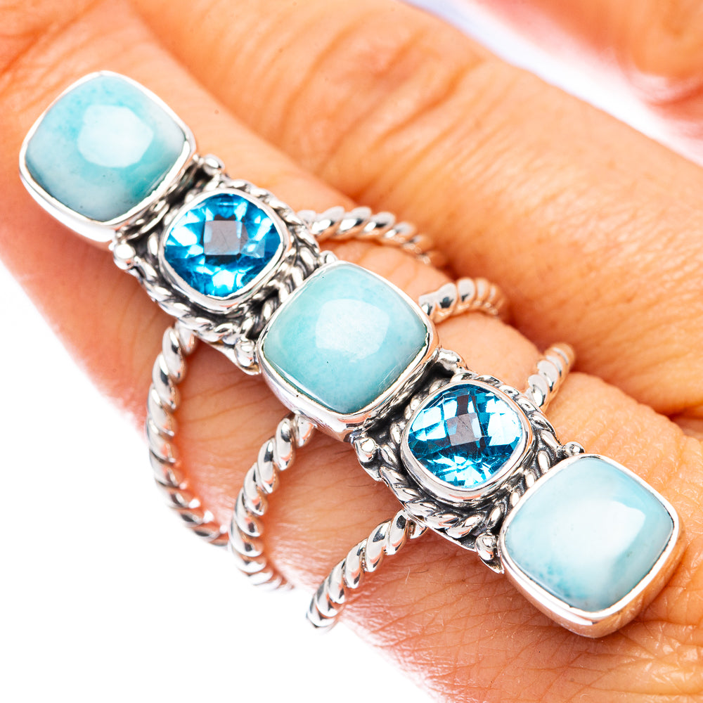 Sterling silver ring on finger with five oval larimar and blue topaz stones
