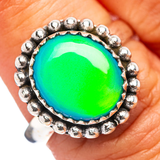Sterling silver opal ring with round green cabochon and beaded halo band