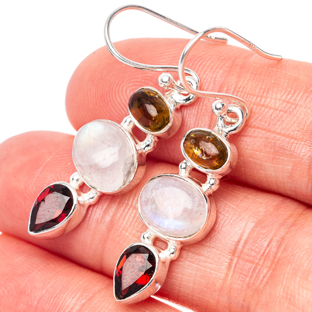 Sterling silver earrings with moonstone rounds, amber oval, and dark red teardrop accents