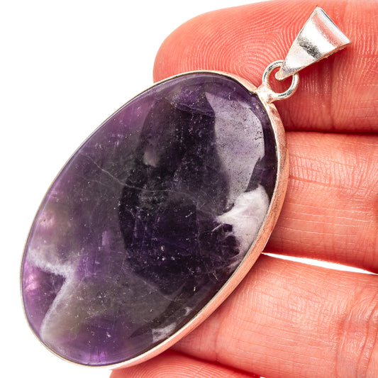 Fluorite pendant with oval purple gemstone and silver bail, natural veining