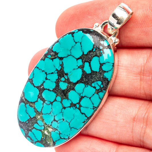 Turquoise oval pendant with black matrix, .925 sterling silver bail
