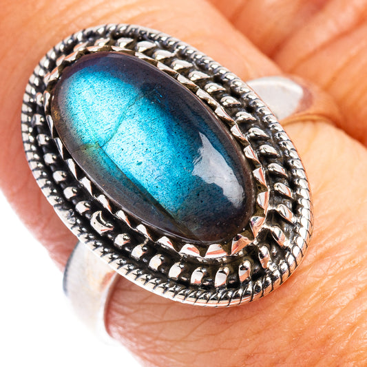 Oval labradorite sterling silver ring with textured bezel and blue flash center
