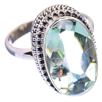 Silver ring with large faceted oval green gemstone and detailed beaded border