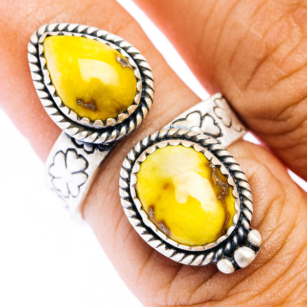 Silver-tone adjustable ring with oval yellow gemstone and rope-edge setting