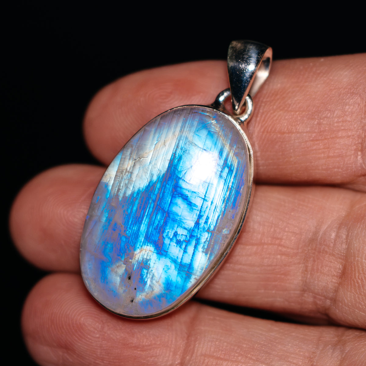 Oval rainbow moonstone pendant, blue cabochon with .925 sterling silver bezel