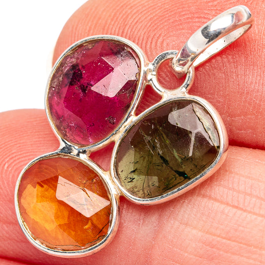Sterling silver tourmaline pendant close-up: magenta, olive-green, and orange stones
