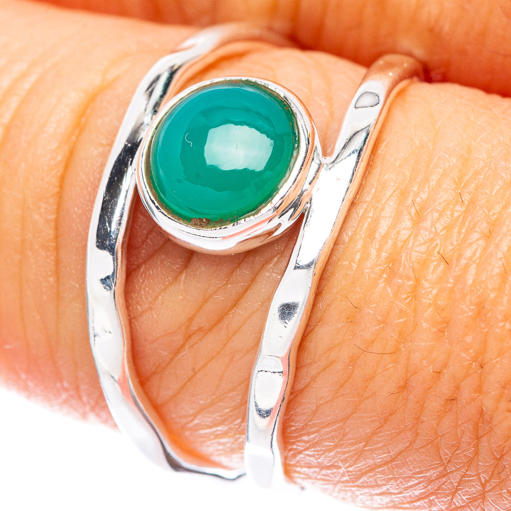 Green onyx dainty ring with oval green stone in silver bezel on finger
