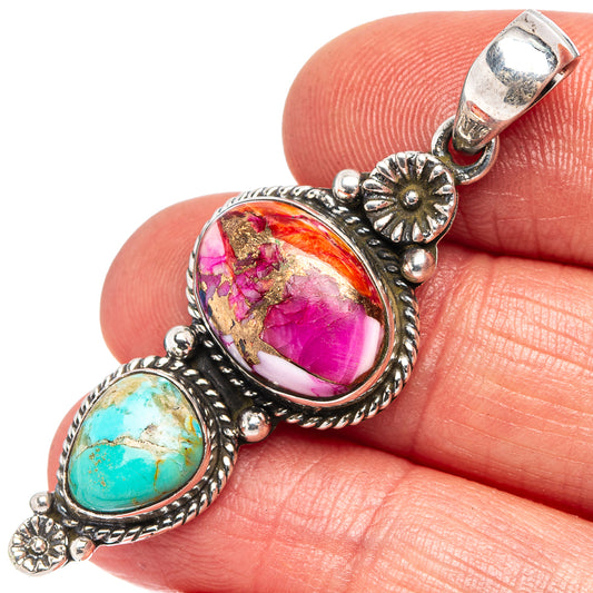 Sterling silver pendant closeup with pink oval stone and turquoise cabochon