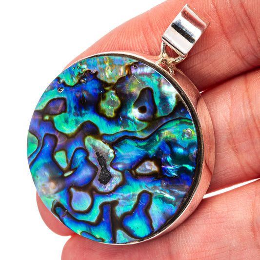Round abalone shell pendant with silver bezel and bail, iridescent blue-green pattern