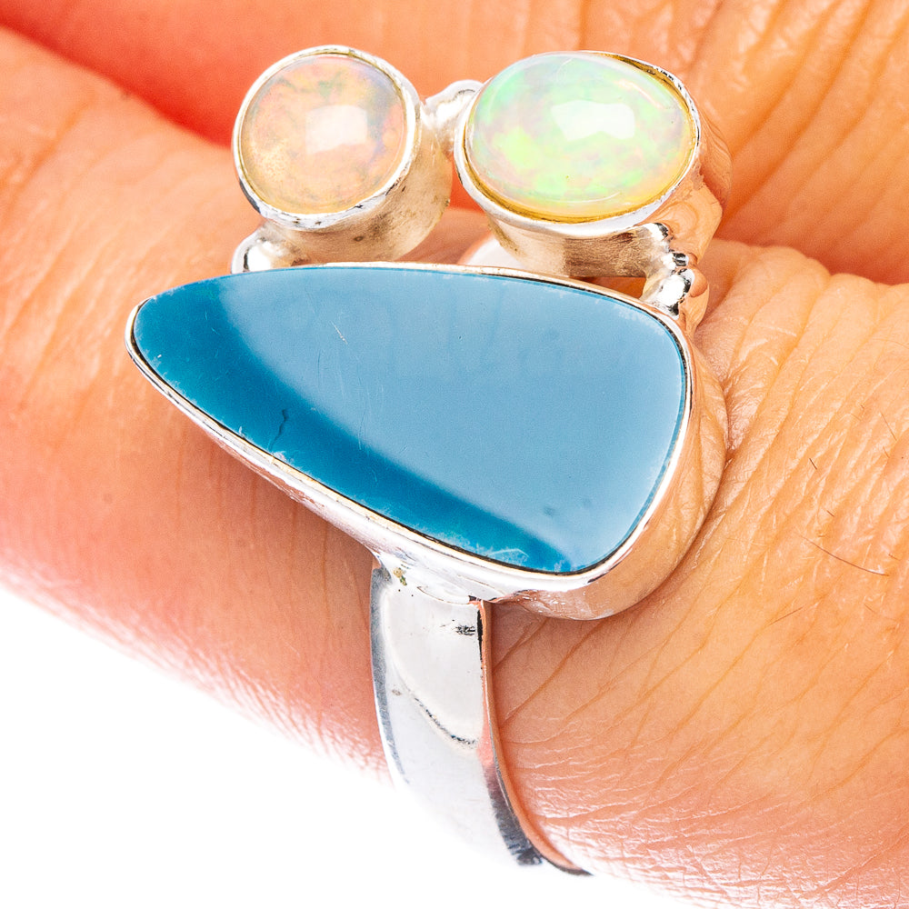Sterling silver opal doublet ring with blue oval center and two round opals