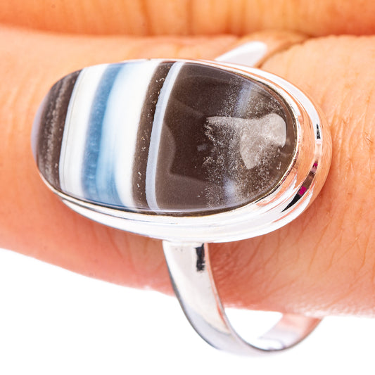 Sterling silver opal ring with oval cabochon, blue and dark striped stone