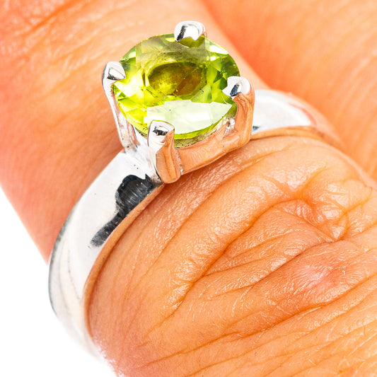 Sterling silver ring with faceted peridot-green gemstone in a four-prong setting