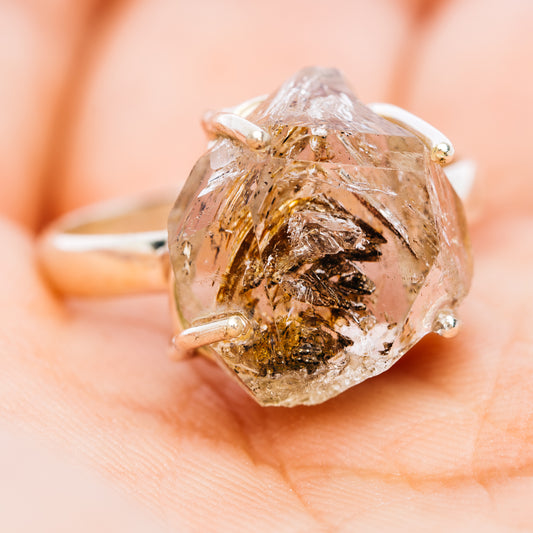 Faceted petroleum quartz ring in sterling silver, showing brown and dark inclusions