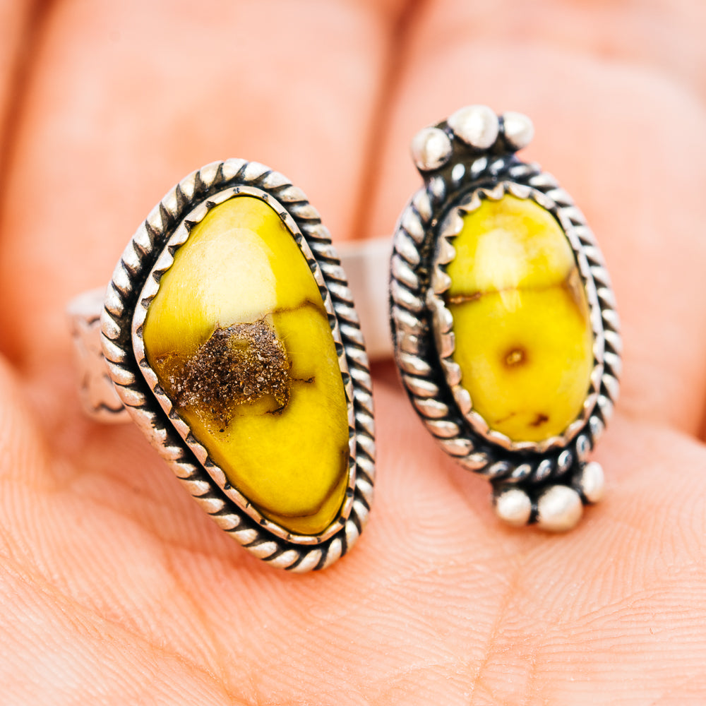 Pair of oval stone sterling silver rings with beaded rope border and small studs