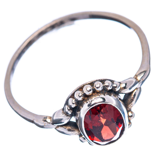 Sterling silver ring with oval dark-red gemstone, scalloped bead halo, and open top view
