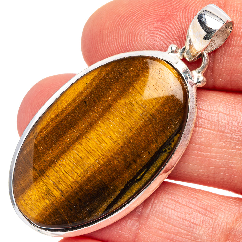 Tiger's eye oval pendant with silver bezel and bail, warm golden brown stone detail