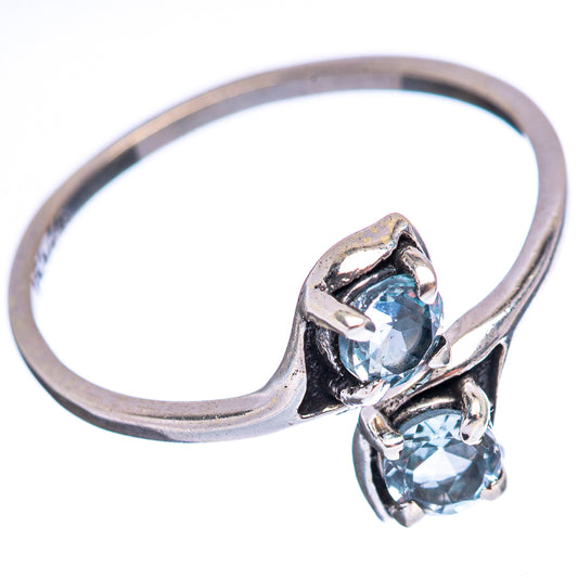 Sterling silver ring with two blue topaz stones in a twisted bezel setting