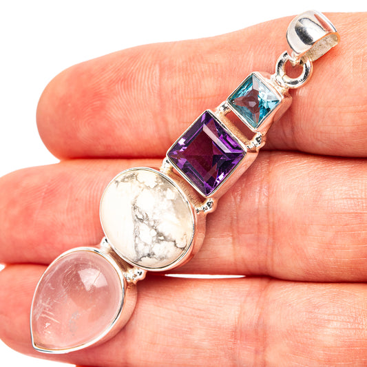 Sterling silver pendant with round white and pink gemstones and blue topaz accents