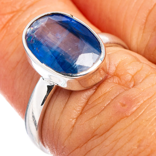Sterling silver ring with oval blue gemstone bezel on finger, size 6