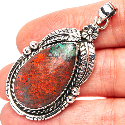 Sterling silver teardrop pendant with red-green Sonora sunrise stone and ornate frame