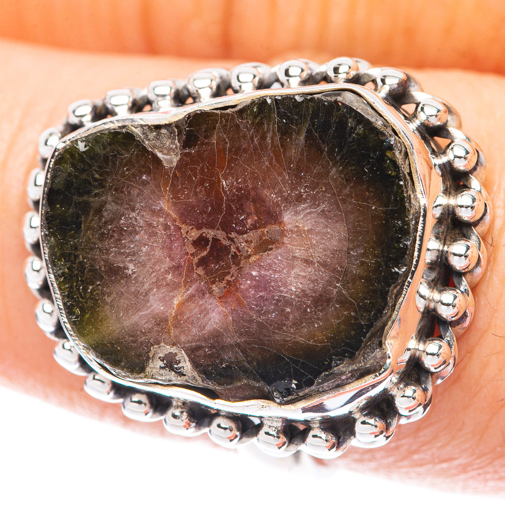 Sterling silver oval tourmaline ring with beaded bezel and dark watermelon-pattern stone.