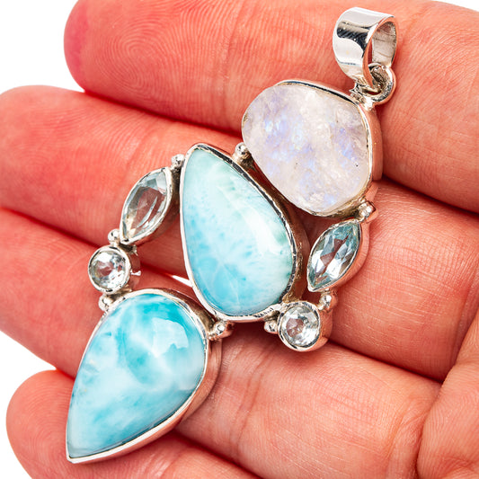 Sterling silver gemstone pendant with large oval blue-green stone and pale opal center