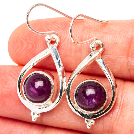 Sterling silver drop earrings with purple ruby cabochons in teardrop settings