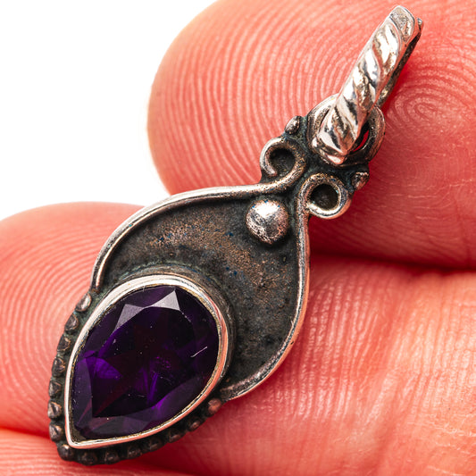 Sterling silver amethyst teardrop pendant with ornate bail and faceted purple gemstone