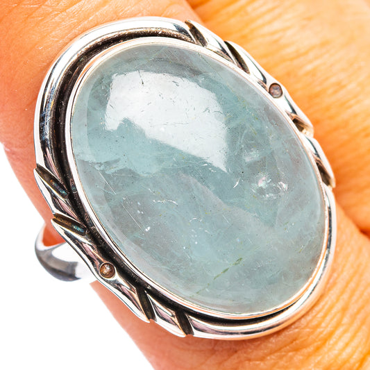 Aquamarine oval sterling silver ring with bezel-set oval stone and decorative frame