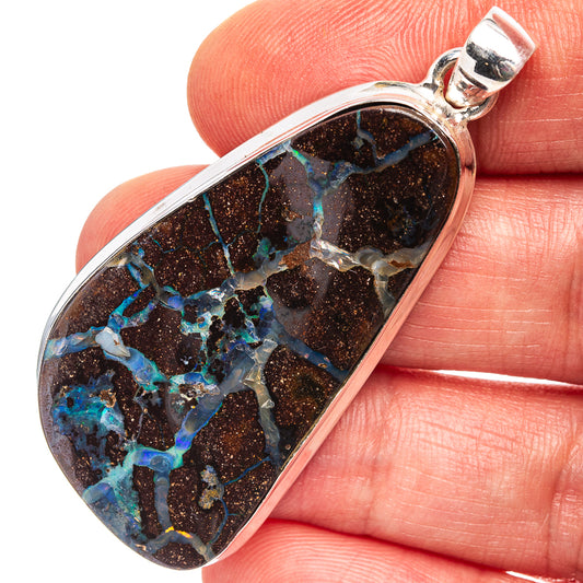 Sterling silver boulder opal pendant with dark matrix and blue-green iridescent stone