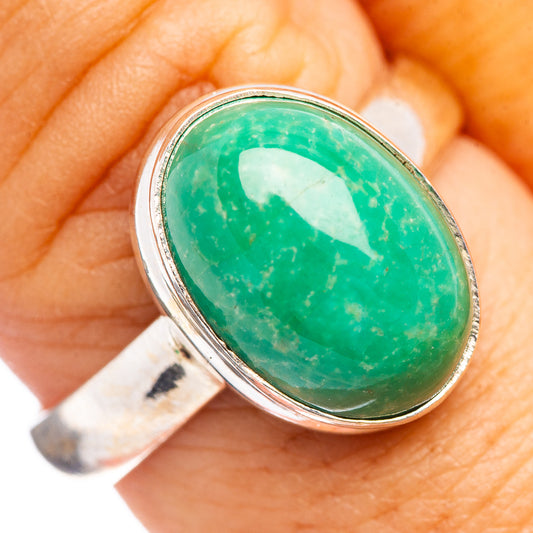 Sterling silver ring with oval green gemstone cabochon and shiny bezel