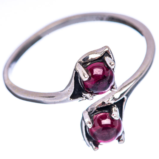 Sterling silver garnet ring with two red gemstones and raised prongs, size 7