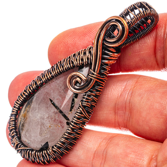 Oxidized copper wire-wrap pendant with teardrop quartz and black inclusions
