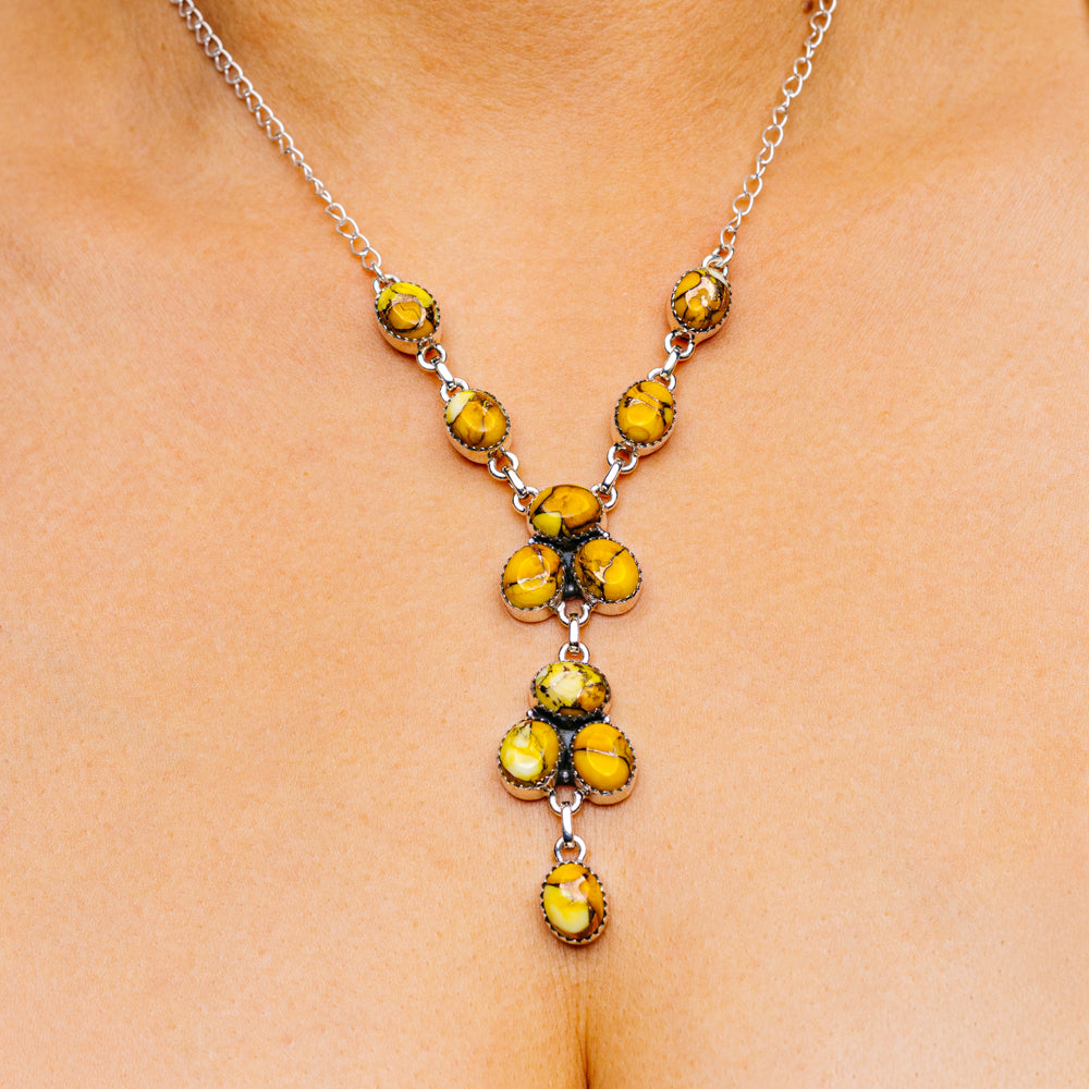 Silver chain necklace with yellow dahlia flower pendant and small turquoise accents