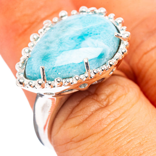 Sterling silver ring with oval blue larimar cabochon and beaded prong halo
