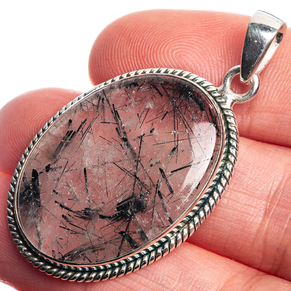 Red tourmalinated quartz pendant in oval sterling silver bezel with dark needle inclusions