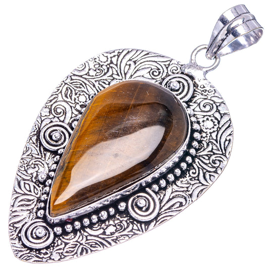 Ornate German silver tiger's eye pendant with teardrop stone and textured edge details