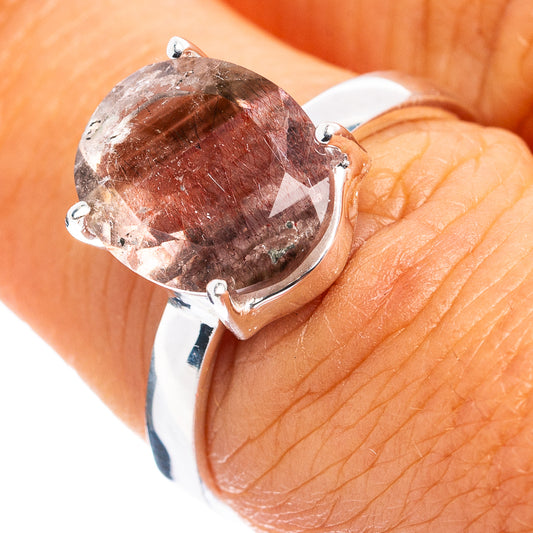 Sterling silver ring with round pink-purple gemstone and three-prong setting