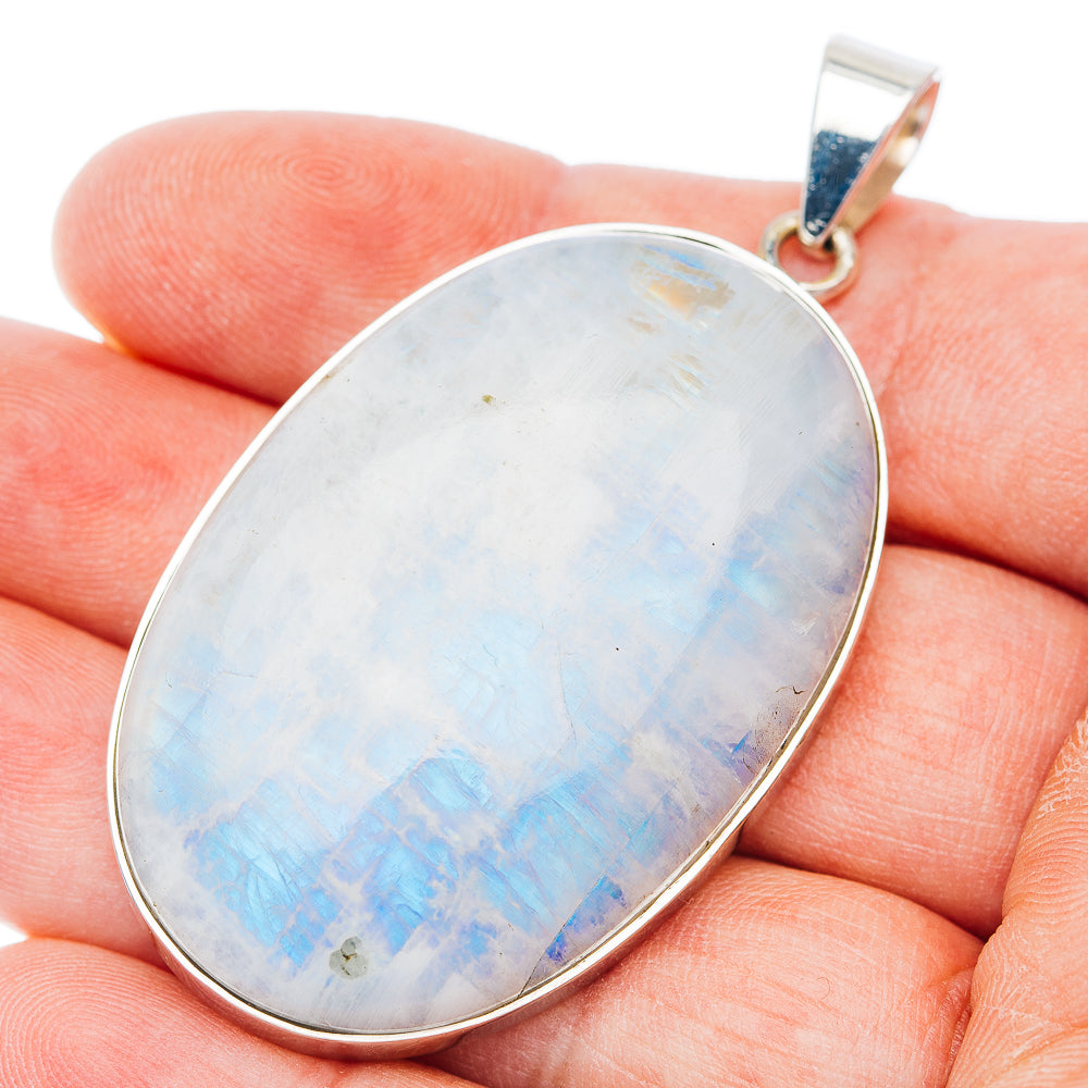 Oval rainbow moonstone pendant in .925 sterling silver, polished bezel and loop bail.