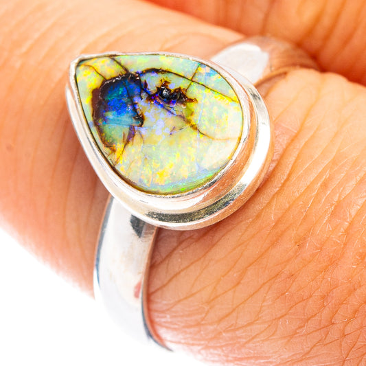 Sterling silver ring with oval opal cabochon in multicolor blue, green, and yellow