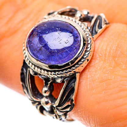Sterling silver ring with oval dark blue tanzanite-style gemstone, ornate bezel
