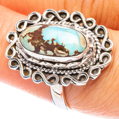 Turquoise cabochon sterling silver ring with oval stone and ornate circular bezel