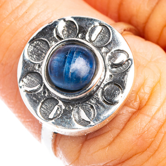 Sterling silver ring with blue oval cabochon kyanite and decorative petal bezel