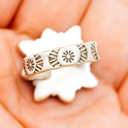 Southwestern silver ring band with etched sunburst and geometric cutout details